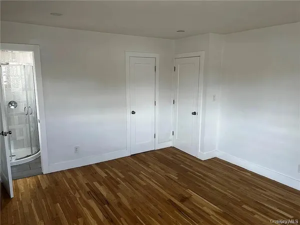 a view of a room with wooden floor and bathroom