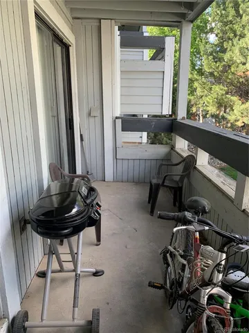a view of a lake with a floor to ceiling window and wooden fence