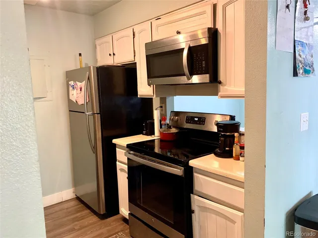 a kitchen with stainless steel appliances granite countertop a stove microwave and refrigerator
