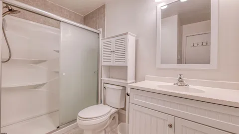 a bathroom with a sink toilet and a mirror