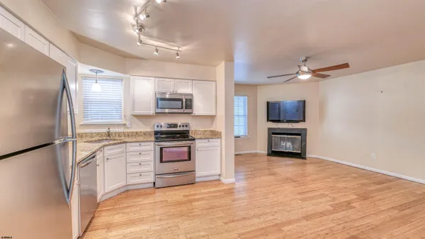 a kitchen with stainless steel appliances a stove a refrigerator sink and cabinets
