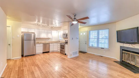 a view of a kitchen with wooden floor and a kitchen