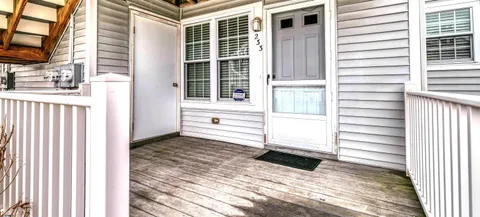 a view of a balcony with a door and a window