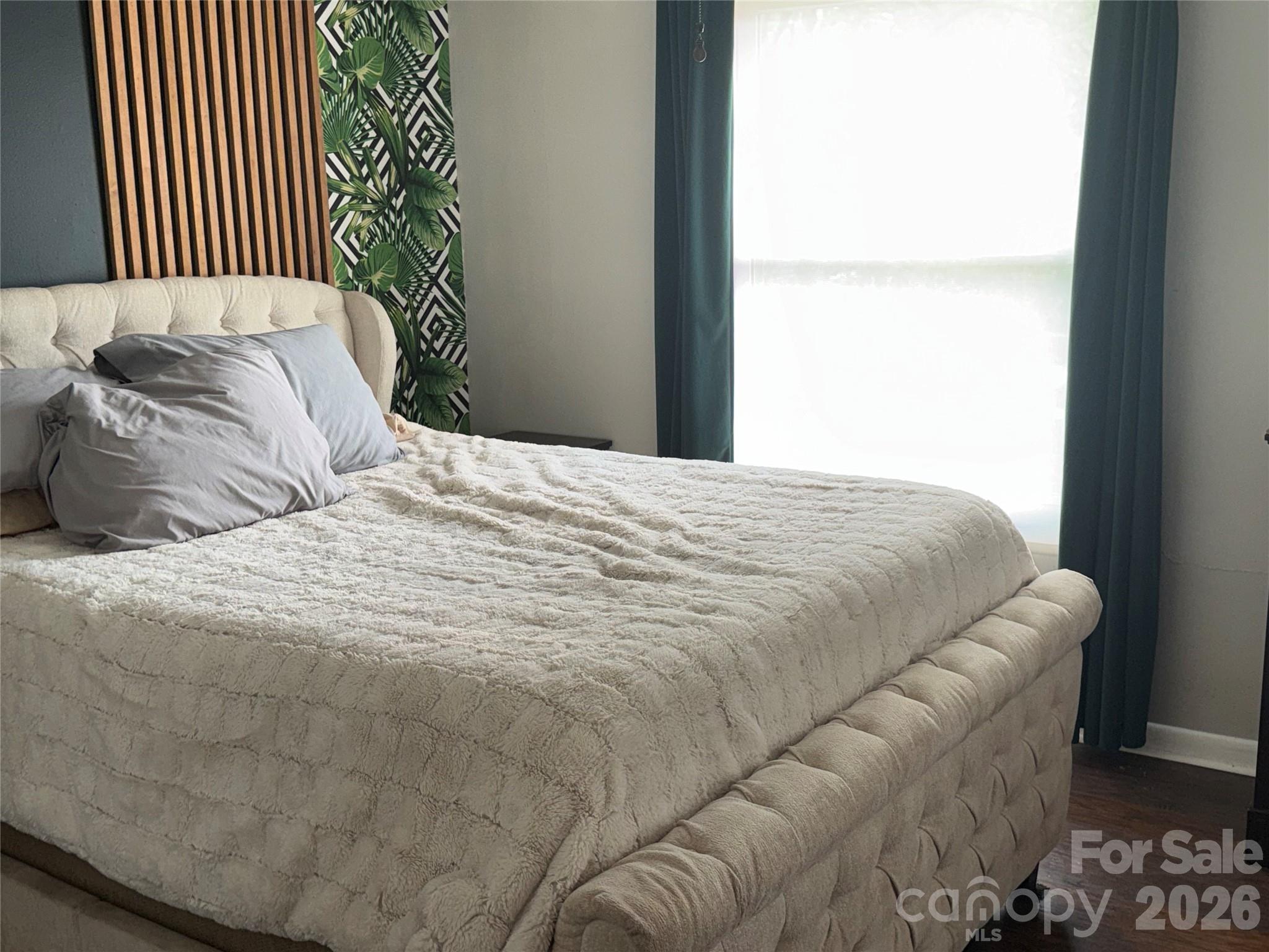 1304 Seaton Road, Unit 15 Durham, NC 27713 - Photo 11 of 20 a bed sitting in a bedroom next to a window