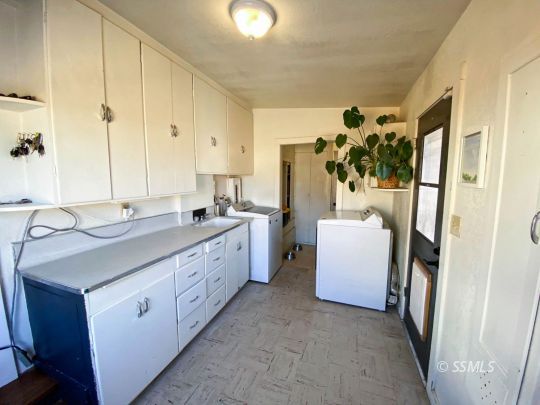 313 North Florence Street Ridgecrest, CA 93555 - Photo 29 of 38 a spacious bathroom with a double vanity sink a mirror and a shower