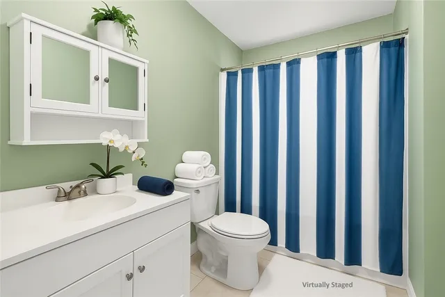 a bathroom with a toilet a sink and a mirror