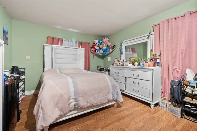a bedroom with a bed and a dresser
