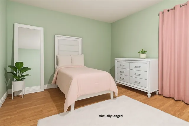 a bedroom with a bed and a potted plant