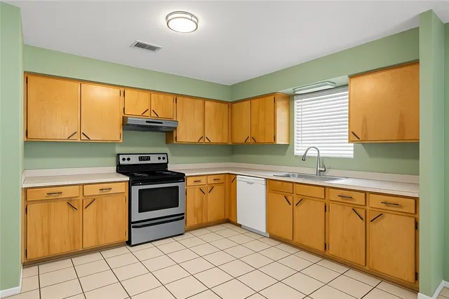 a kitchen with stainless steel appliances granite countertop a sink and cabinets