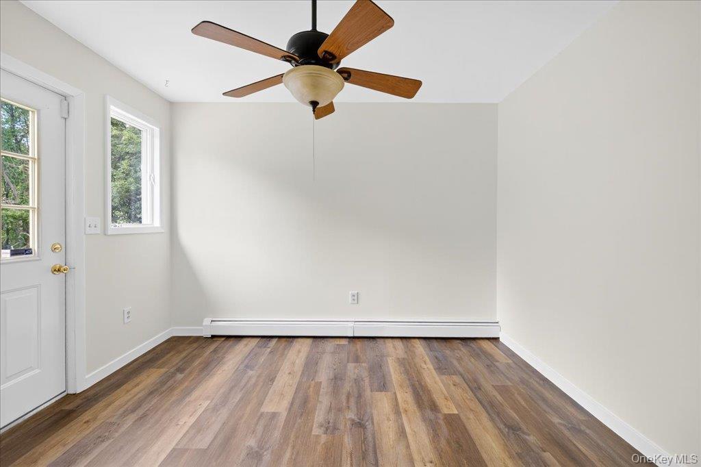 226 Knoth Road Wallkill, NY 12589 - Photo 13 of 34 an empty room with wooden floor and windows