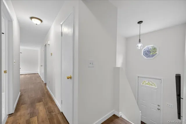 a view of a hallway with wooden floor
