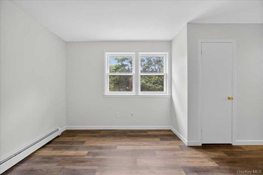 226 Knoth Road Wallkill, NY 12589 - Photo 17 of 34 a view of an empty room with wooden floor and a window
