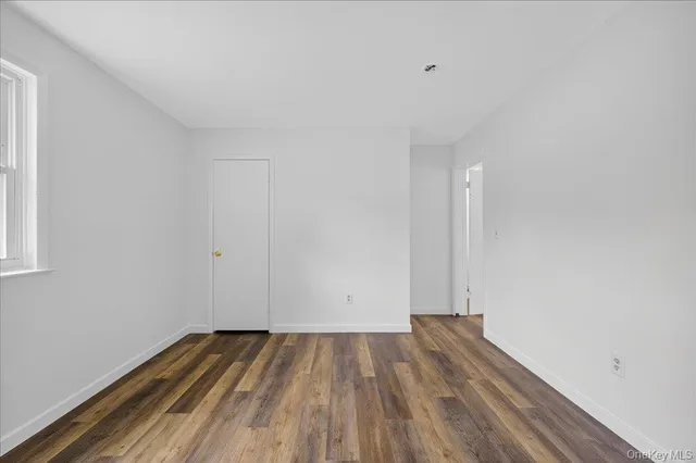 a view of room with wooden floor and window