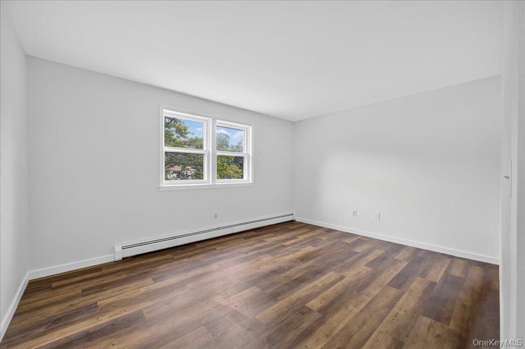 226 Knoth Road Wallkill, NY 12589 - Photo 5 of 34 an empty room with wooden floor and windows