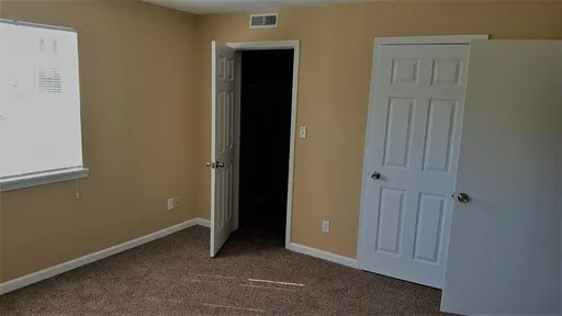 a view of walk in closet with clothes