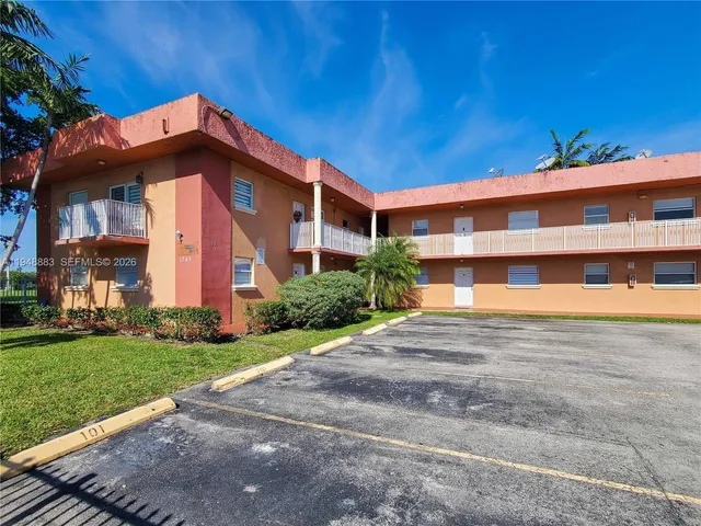 a front view of a building with a yard