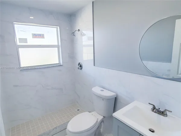 a white toilet sitting next to a bathroom sink