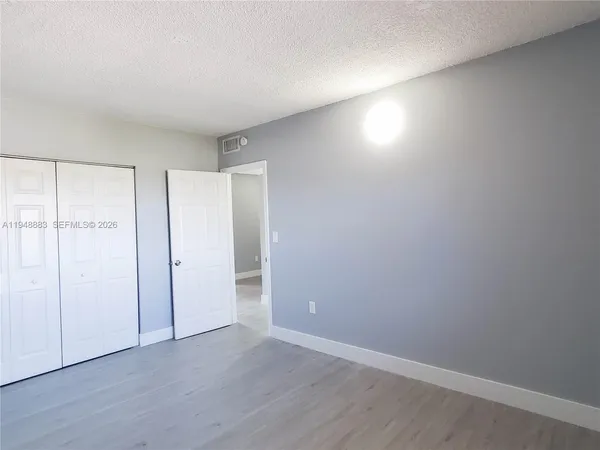 a view of an empty room and wooden floor