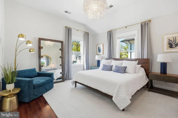 a bedroom with a bed couch and a window