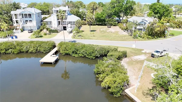 an aerial view of a house with a yard and lake view