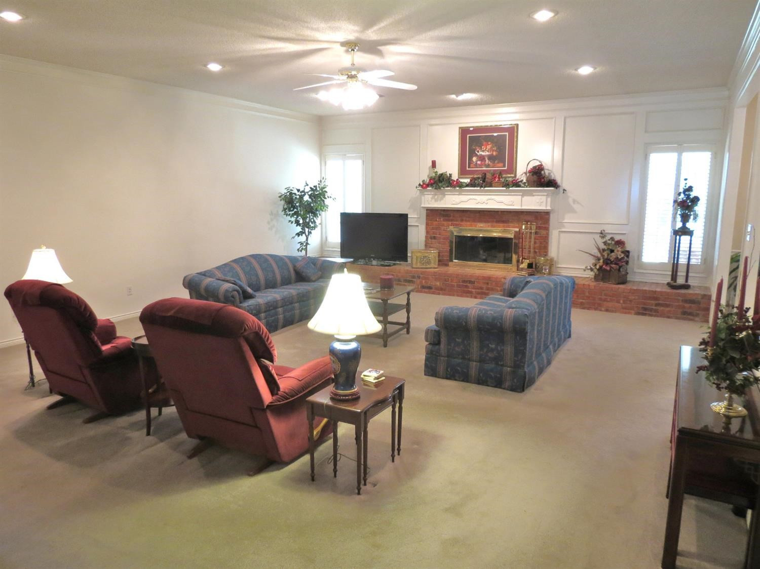 1310 17th Street Ralls, TX 79357 - Photo 4 of 10 a living room with furniture and a fireplace