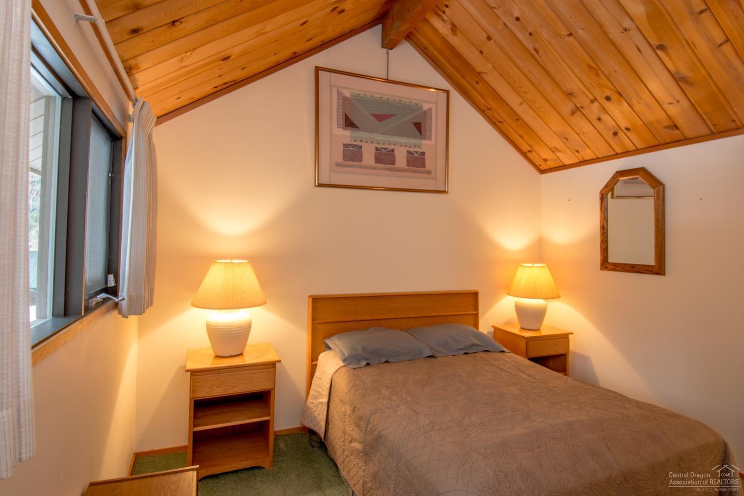 13 Ranch Cabin Road Sunriver, OR 97707 - Photo 12 of 21 a bedroom with a bed and wooden floor