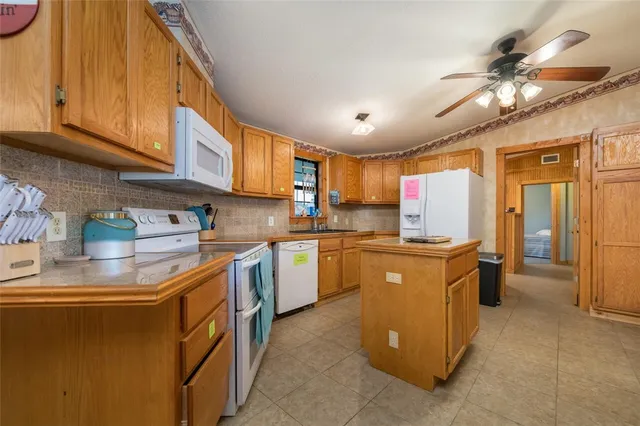 a kitchen with a stove and a chandelier