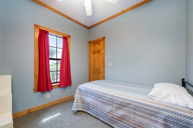 a bedroom with a bed and window