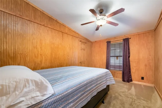 a living room with furniture a fireplace and a large window