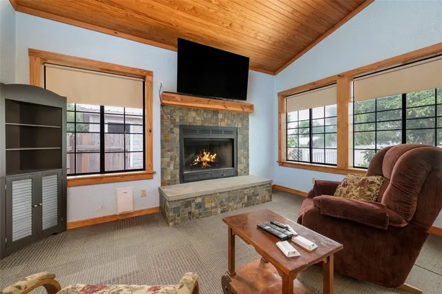 a living room with furniture wooden floor and a chandelier