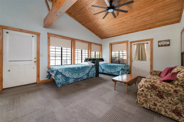 a backyard of a house with lots of green space and lake view in back