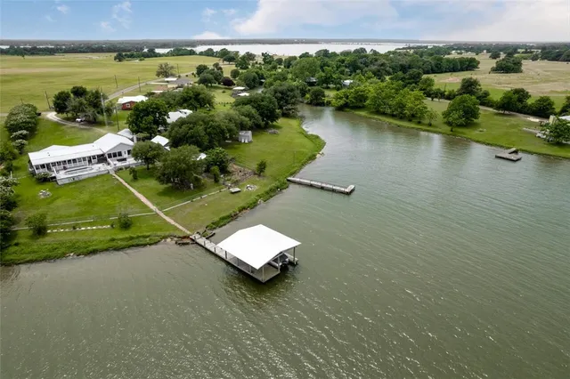 an aerial view of a house with a lake view