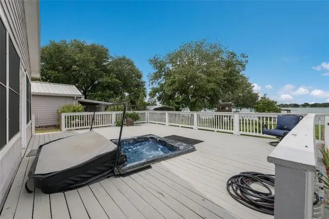 a view of a balcony with wooden floor and fence