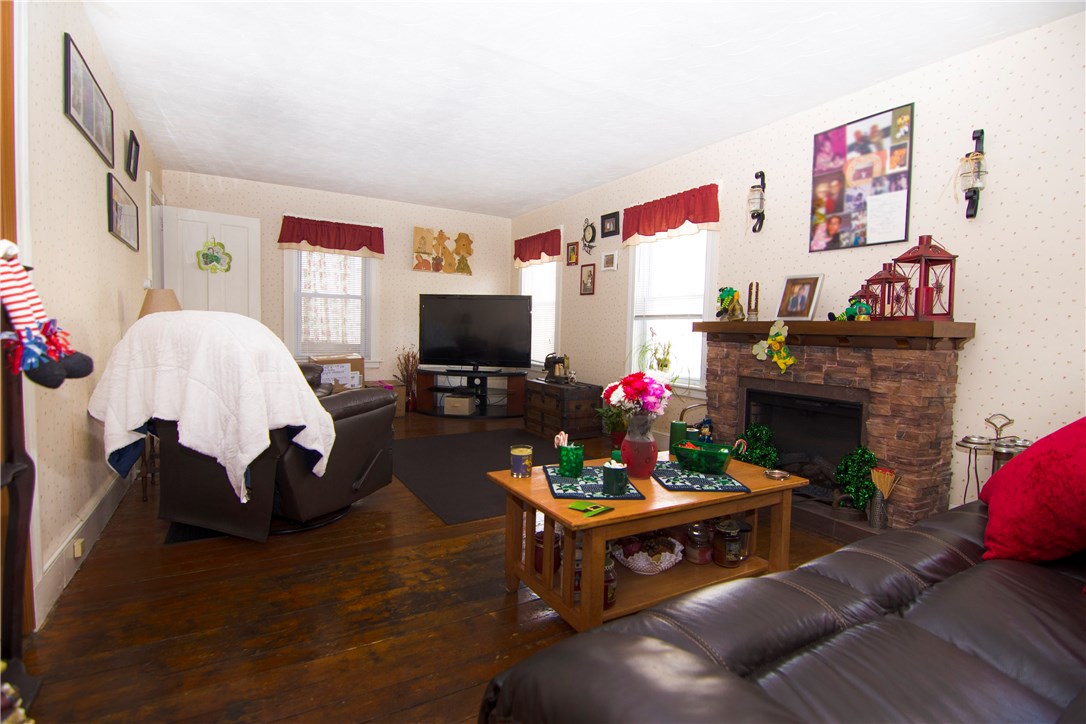 5 Beckside Road North Providence, RI 02911 - Photo 21 of 32 Spacious living room in tenants side has multiple windows and hardwood flooring.
