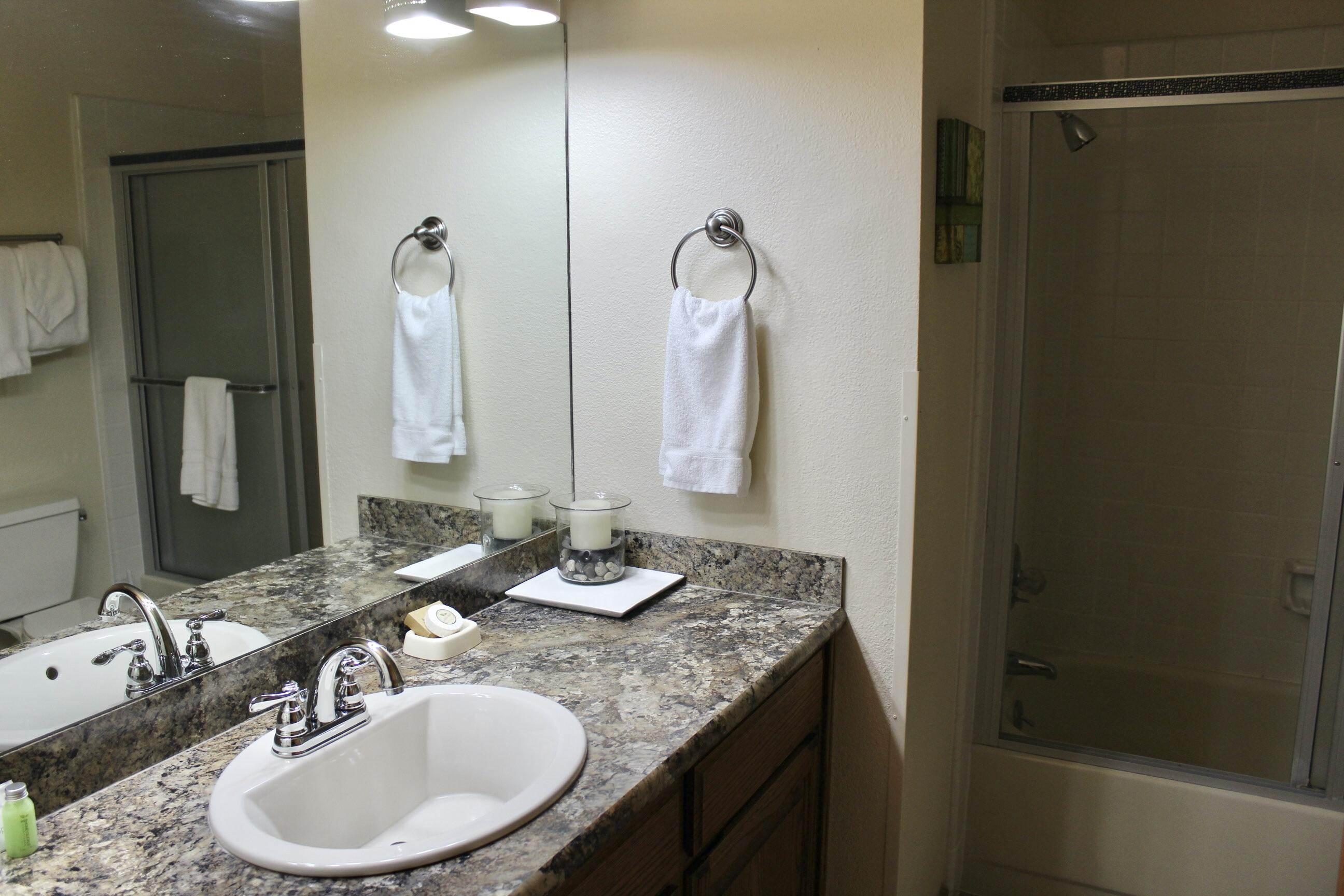 57307 Beaver Ridge Loop, Unit 7C Sunriver, OR 97707 - Photo 12 of 21 a bathroom with a granite countertop sink and a mirror