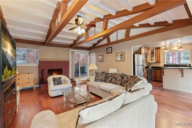 a living room with furniture wooden floor and a flat screen tv