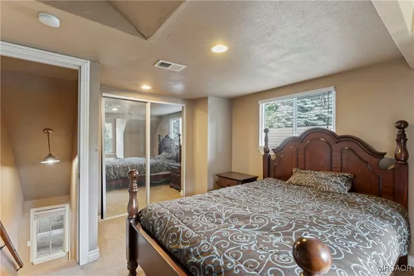 a bedroom with a large bed and a chandelier