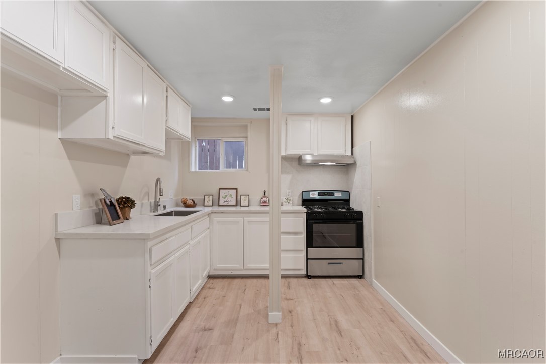 26791 Highway 189 Twin Peaks, CA 92391 - Photo 20 of 39 a kitchen with a sink a stove and cabinets