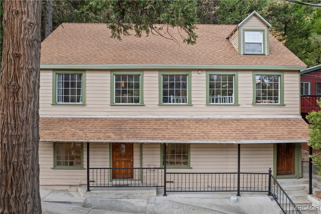 26791 Highway 189 Twin Peaks, CA 92391 - Photo 2 of 39 a view of a brick house with many windows