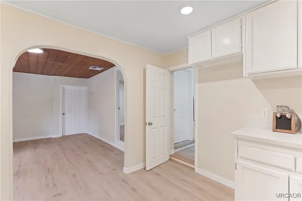 a view of a kitchen cabinets and wooden floor