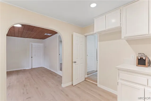 a view of a kitchen cabinets and wooden floor