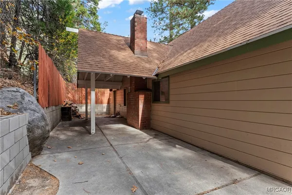 a view of a house with a wooden fence