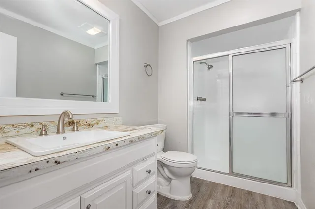 a bathroom with a sink toilet and shower