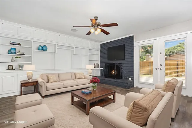 a living room with furniture a fireplace and a flat screen tv