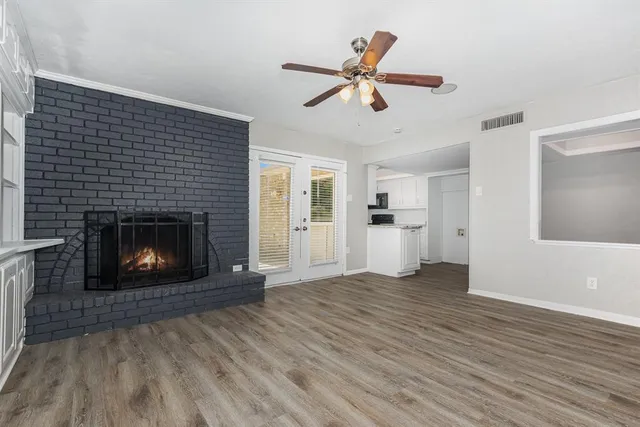 a view of a livingroom with a fireplace and window