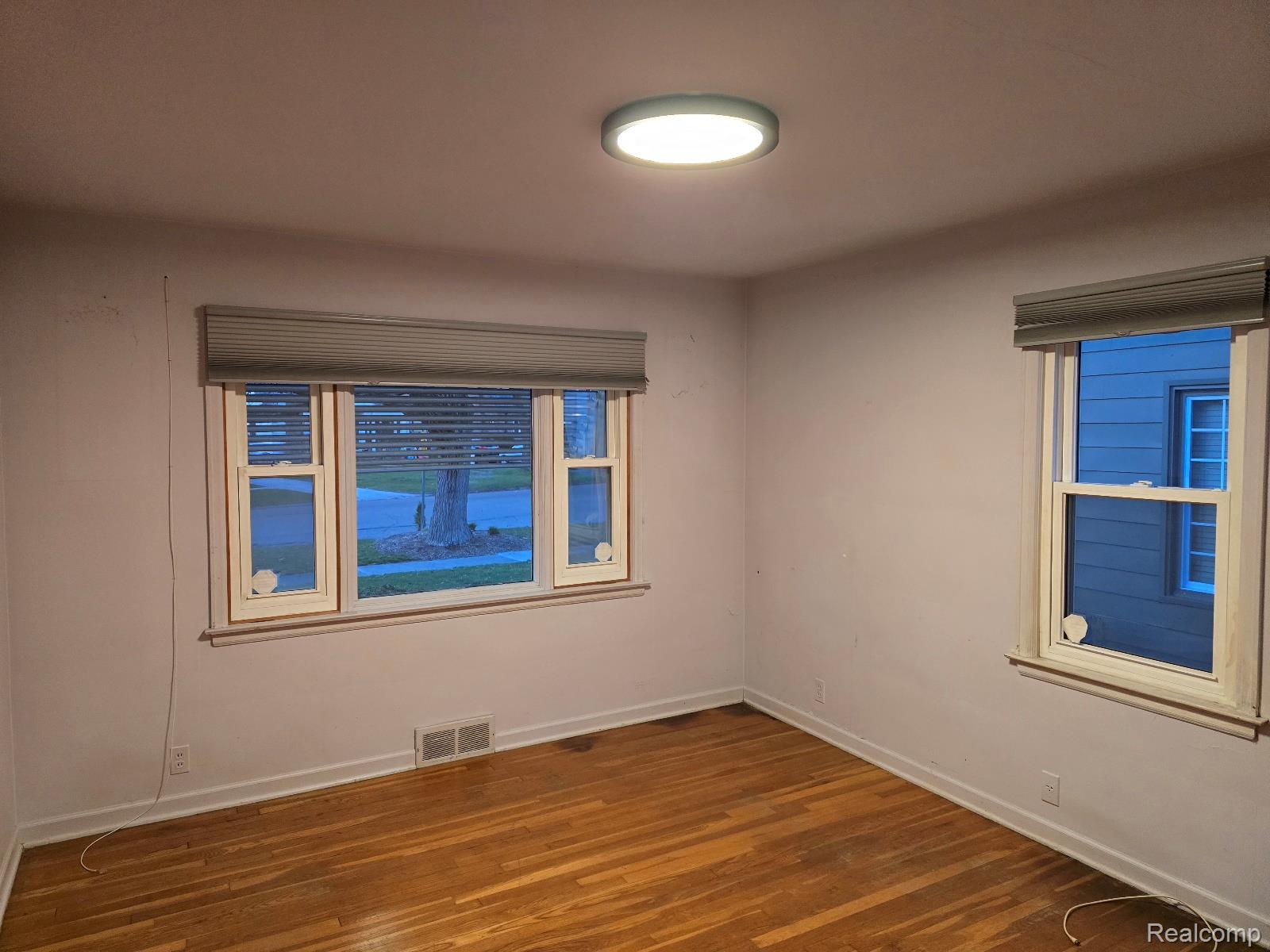 803 Commonwealth Avenue Flint, MI 48503 - Photo 13 of 15 Unfurnished room featuring dark wood finished floors and baseboards