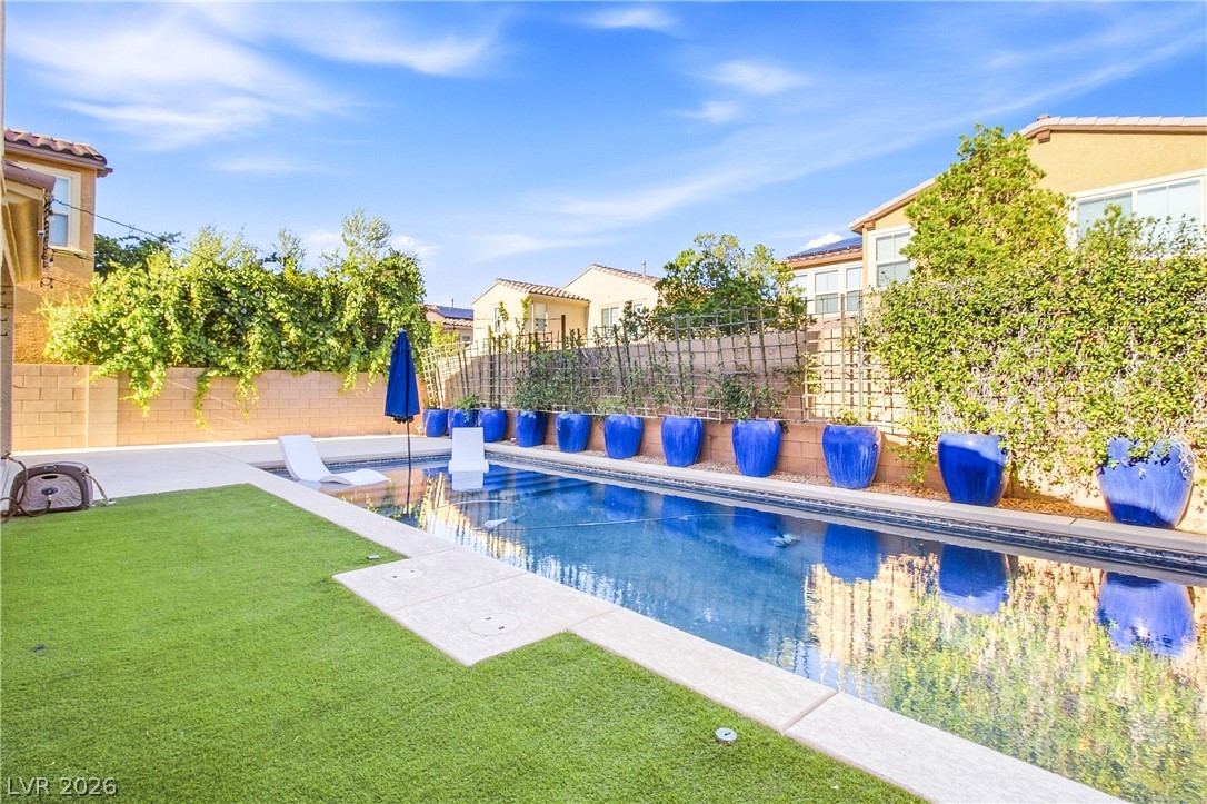 2182 Trivero Street Henderson, NV 89044 - Photo 44 of 50 An inviting swimming pool serves as the centerpiece of this private, low-maintenance backyard retreat.