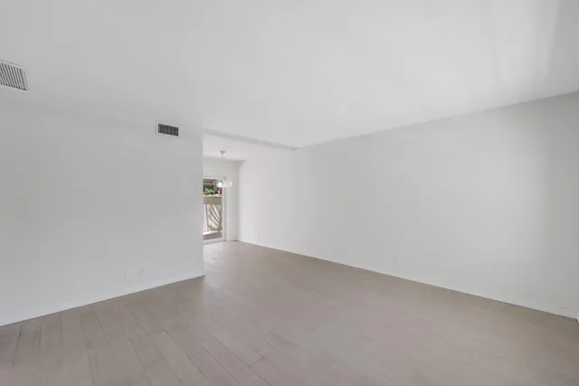 a view of an empty room and a window