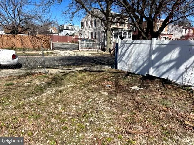 a view of yard covered with snow in front of house