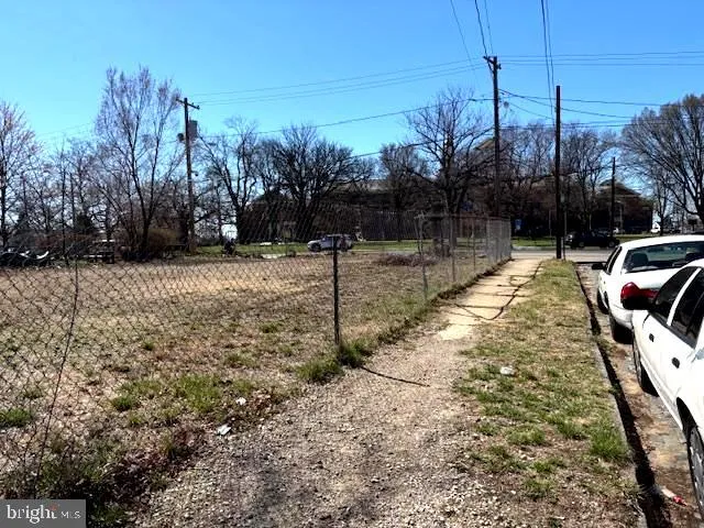a view of a yard with wooden fence